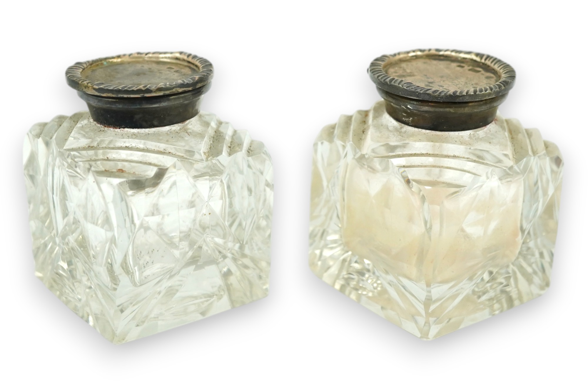 A pair of silver mounted cut glass inkwells, maker JT, height 66mm. Condition - fair to good